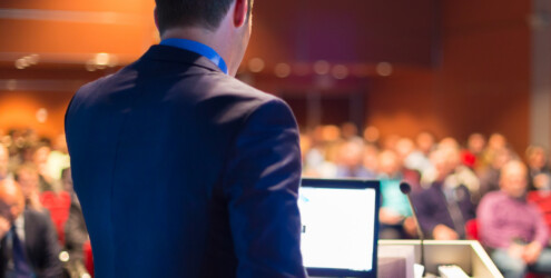 Corey Quinn speaking at a conference