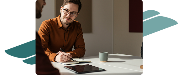 Man sitting at desk with tablet